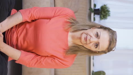 Vertical-video-of-Woman-looking-at-camera-with-dull-expression.